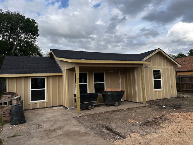 Home addition framing with new roof, siding and windows installed